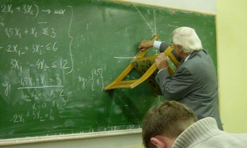 Using A Chair To Draw A Straight Line On A Chalkboard