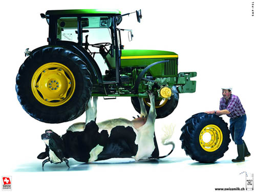 Swiss Milk Ad | Cow Holding Up A John Deere Tractor While Farmer Changes A Tire