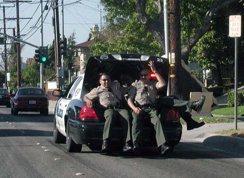 Police Officers Riding In Cop Car Trunk