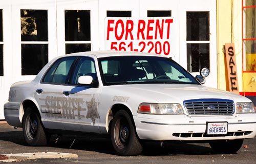 Rent Sign Behind Police Car