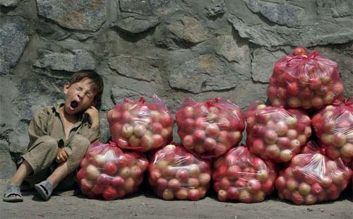 Kid Yawning While Selling Apples