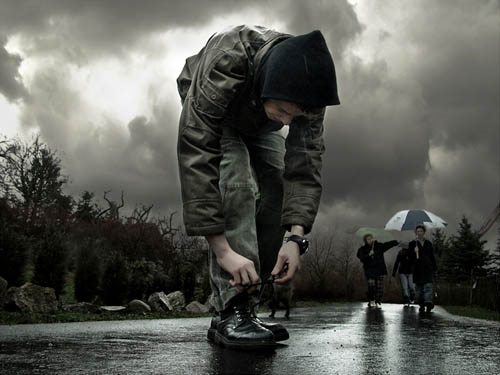 Boy Ties His Shoe As Storm Brews | Photography By Frank Melech