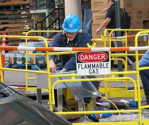 Flammable Gas Sign With Worker Smoking